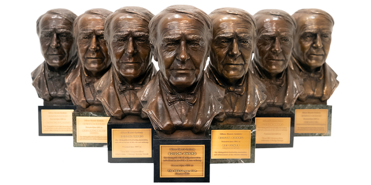 Multiple Edison Awards bronze bust trophies displayed in a row, recognizing innovation and excellence in the energy industry.