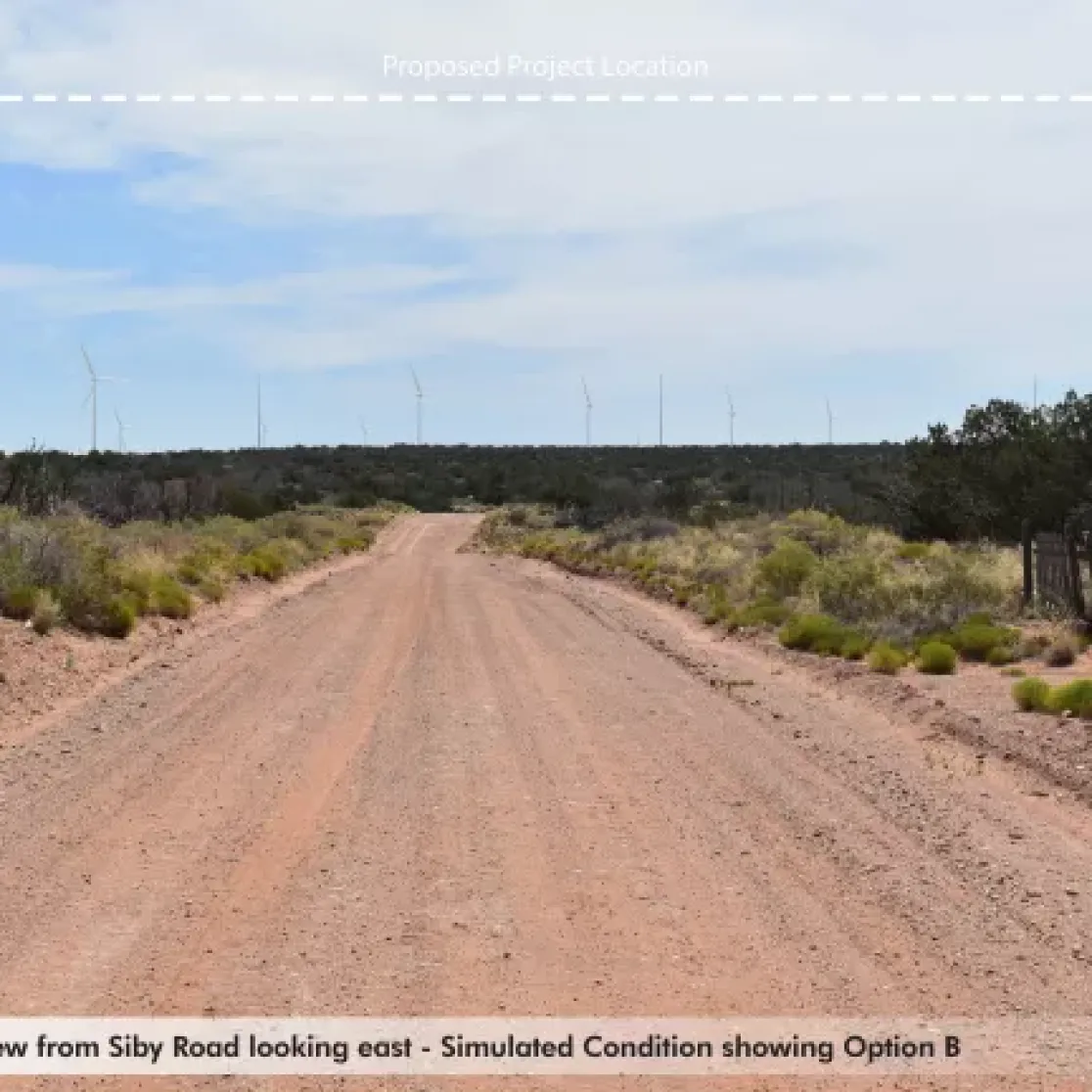 A dirt road stretches into the distance, bordered by shrubs and trees under a partly cloudy sky. Wind turbines are visible on the horizon. A dashed line labeled 'Proposed Project Location' appears above the turbines. The caption reads: 'Siby Road KOP: View from Siby Road looking east - Simulated Condition showing Option B.'