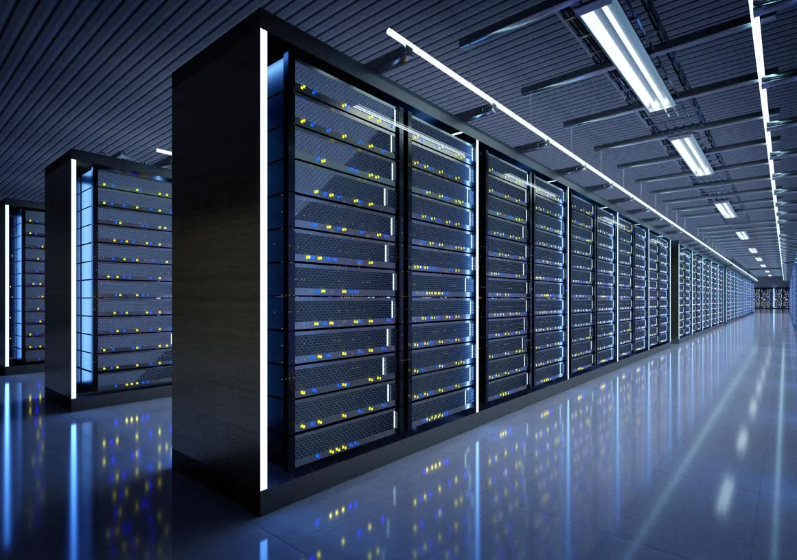 A modern data center with rows of server racks illuminated by blue and white lights, reflecting on the polished floor.