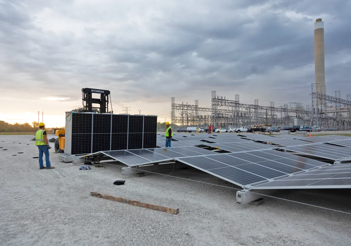workers-installing-solar-panels-at-power-plant.jpg 