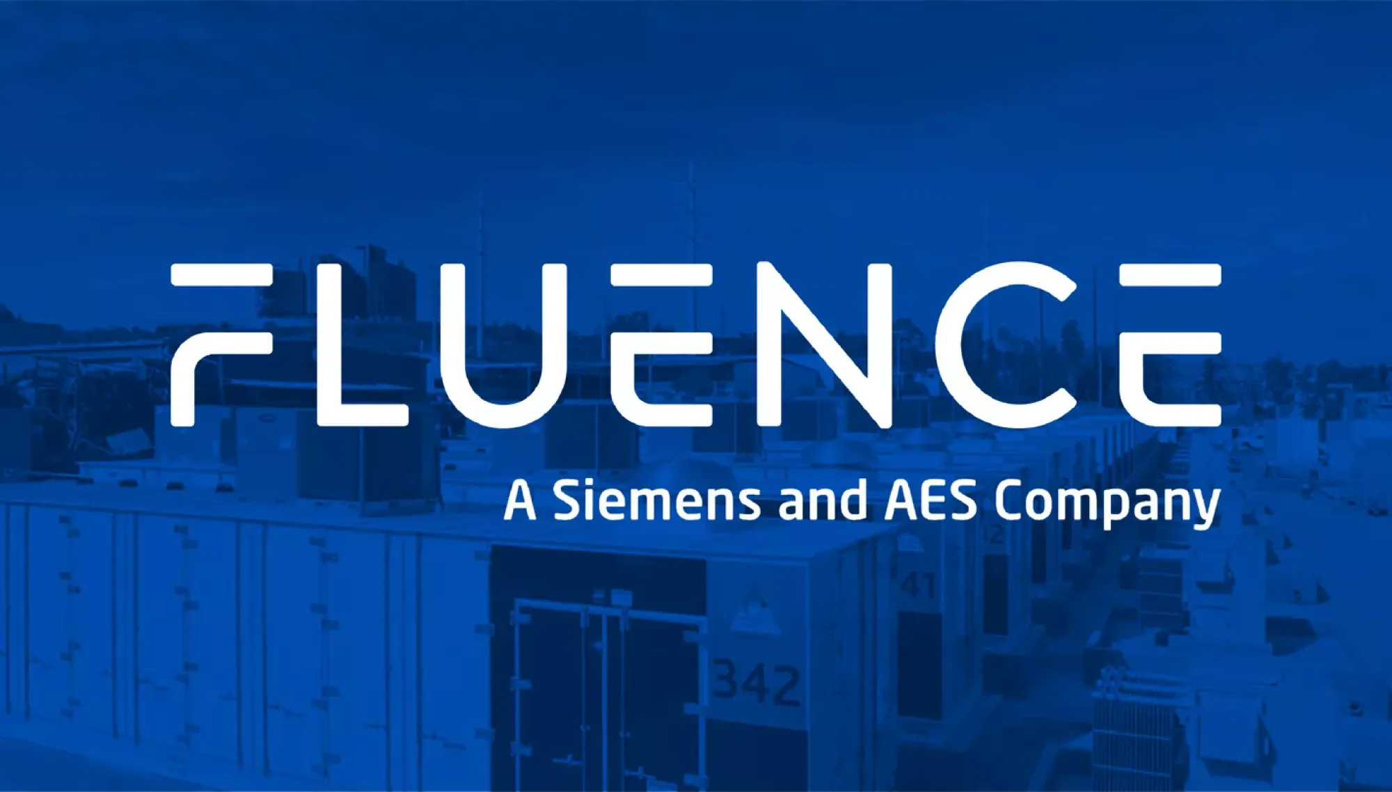 Image showing the Fluence logo with the text 'A Siemens and AES Company' over a blue-tinted background of industrial equipment.