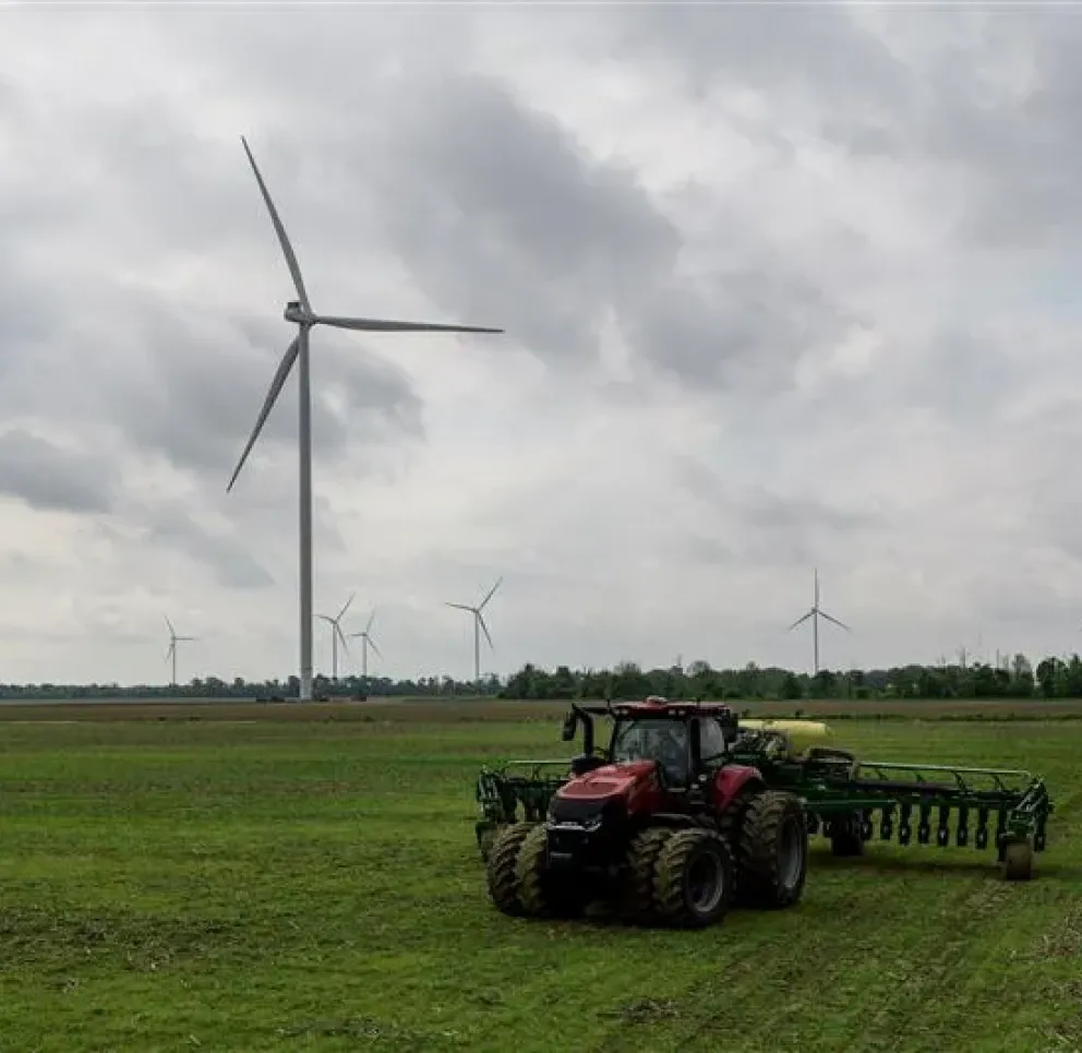 wind-turbines-in-farm-field-with-tractor.jpg