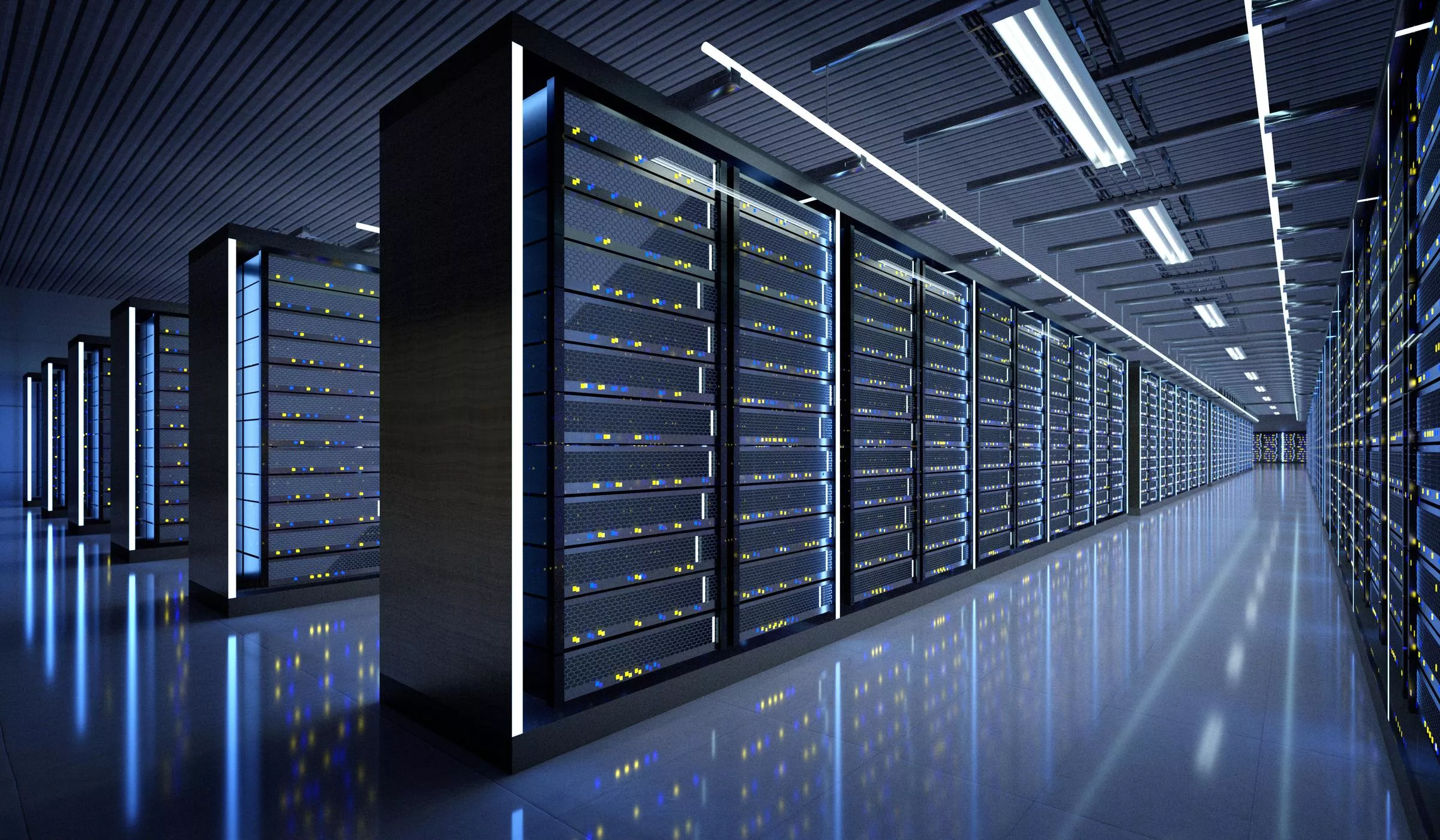 A modern data center with rows of server racks illuminated by blue and white lights, reflecting on the polished floor.