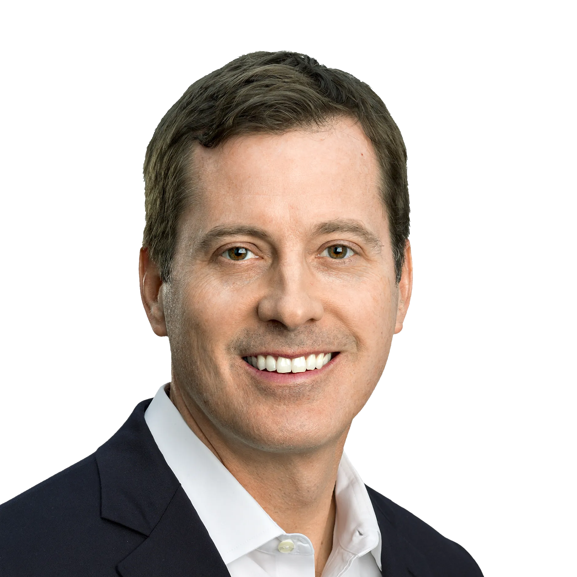 A man in a dark suit and white shirt smiling against a white background.