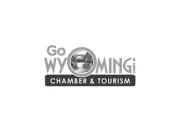 Logo of Go Wyoming Chamber & Tourism with a circular image of a landscape in the center.